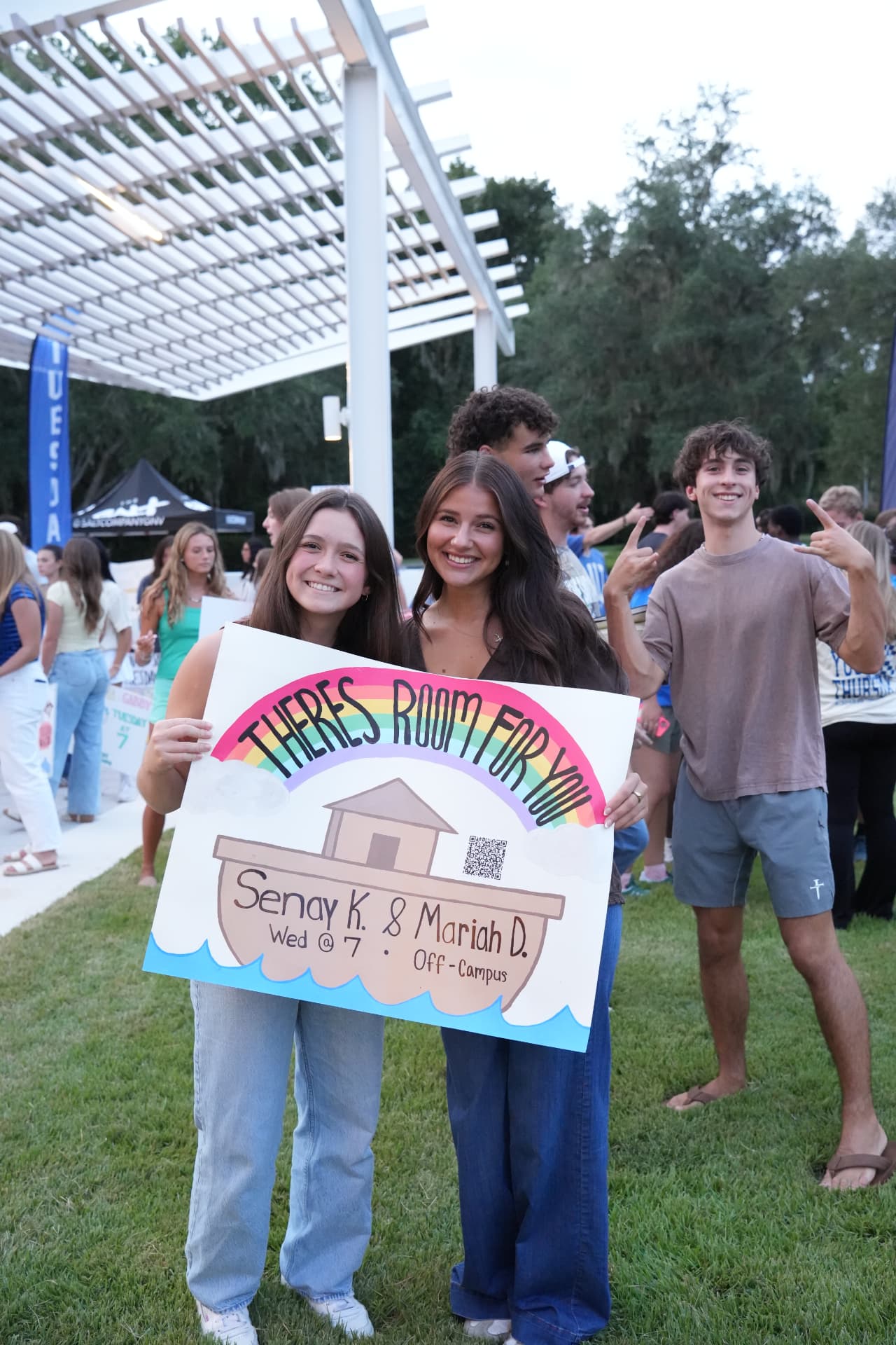 Students holding a 'There's room for you' sign at a Salt Company gathering