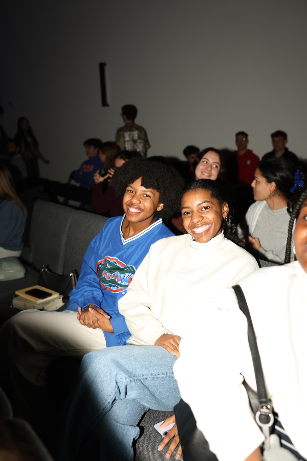 Two students smiling together in their seats