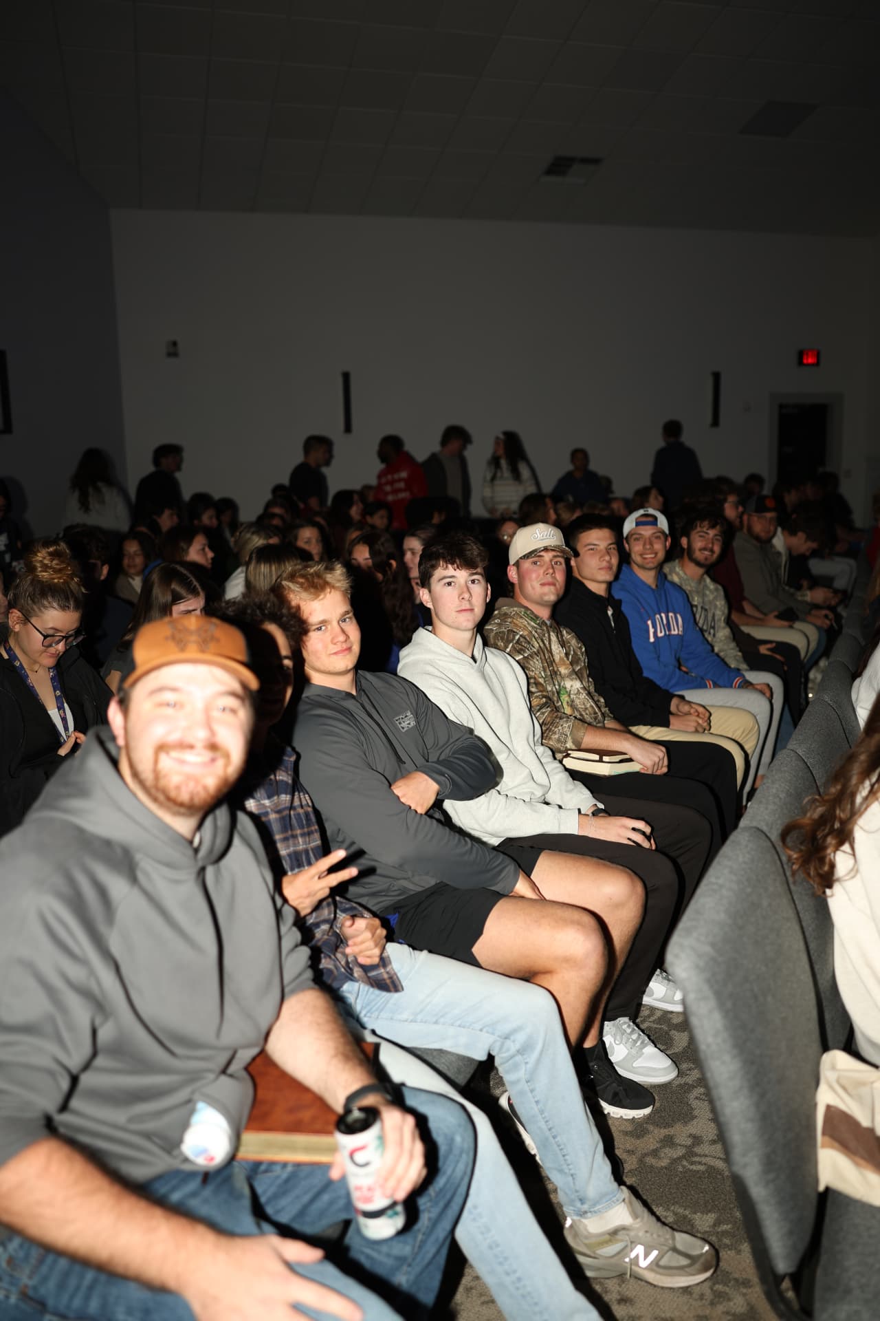 Rows of students seated together before the gathering begins