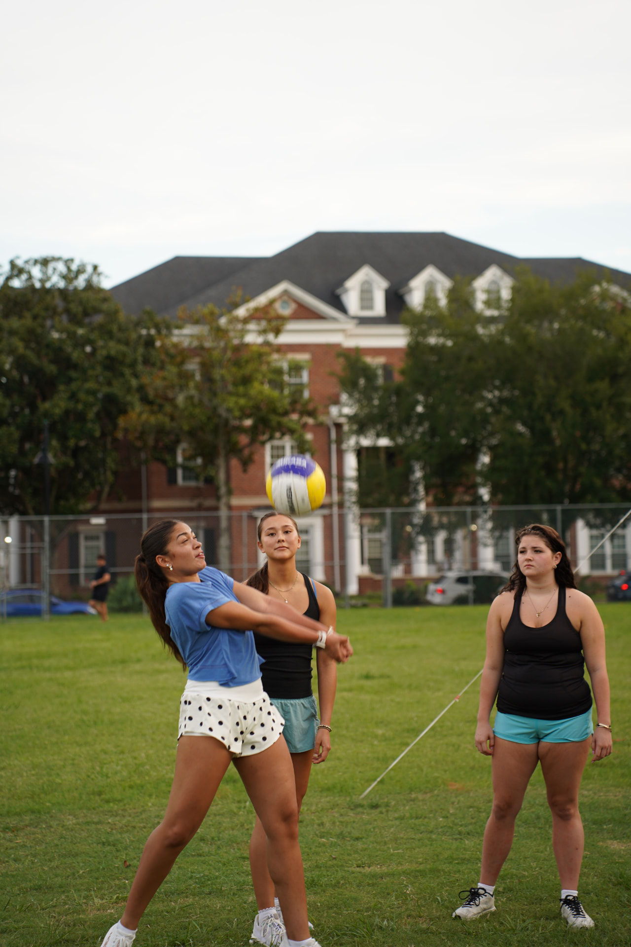 Students playing intramural volleyball on campus